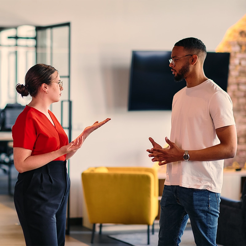 Man and woman talking in an office setting